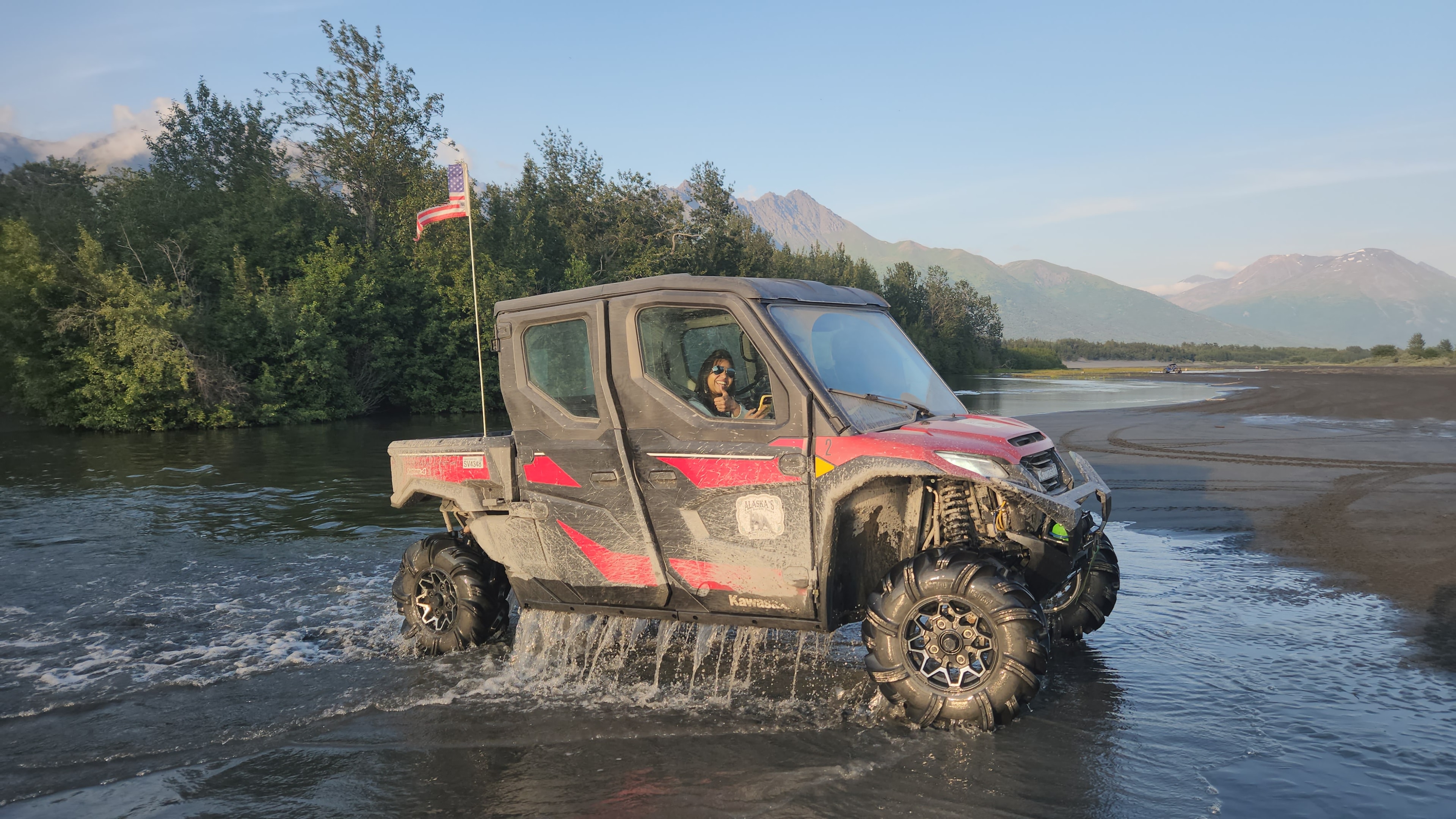 Enclosed UTV navigating Alaska backcountry terrain